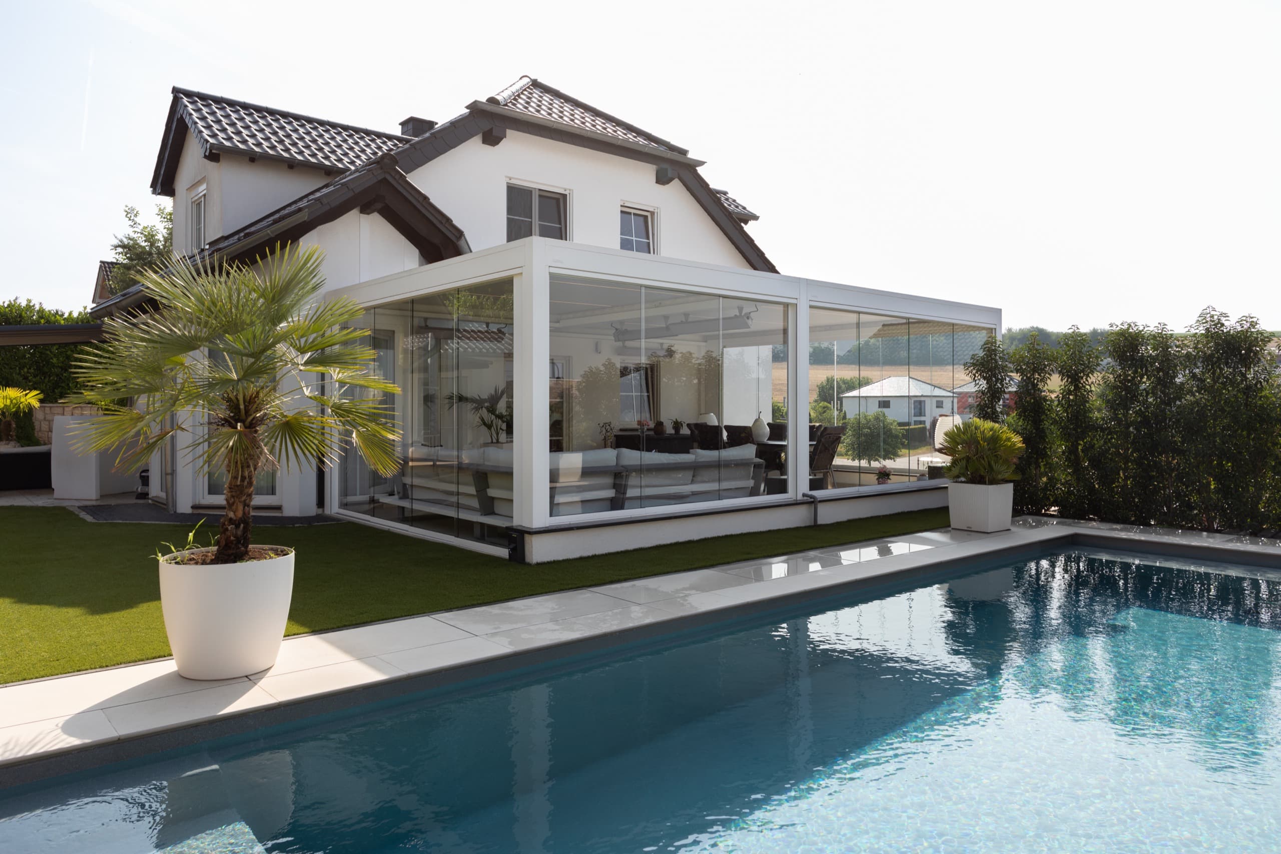 Residential pergola with outdoor dining area by the pool