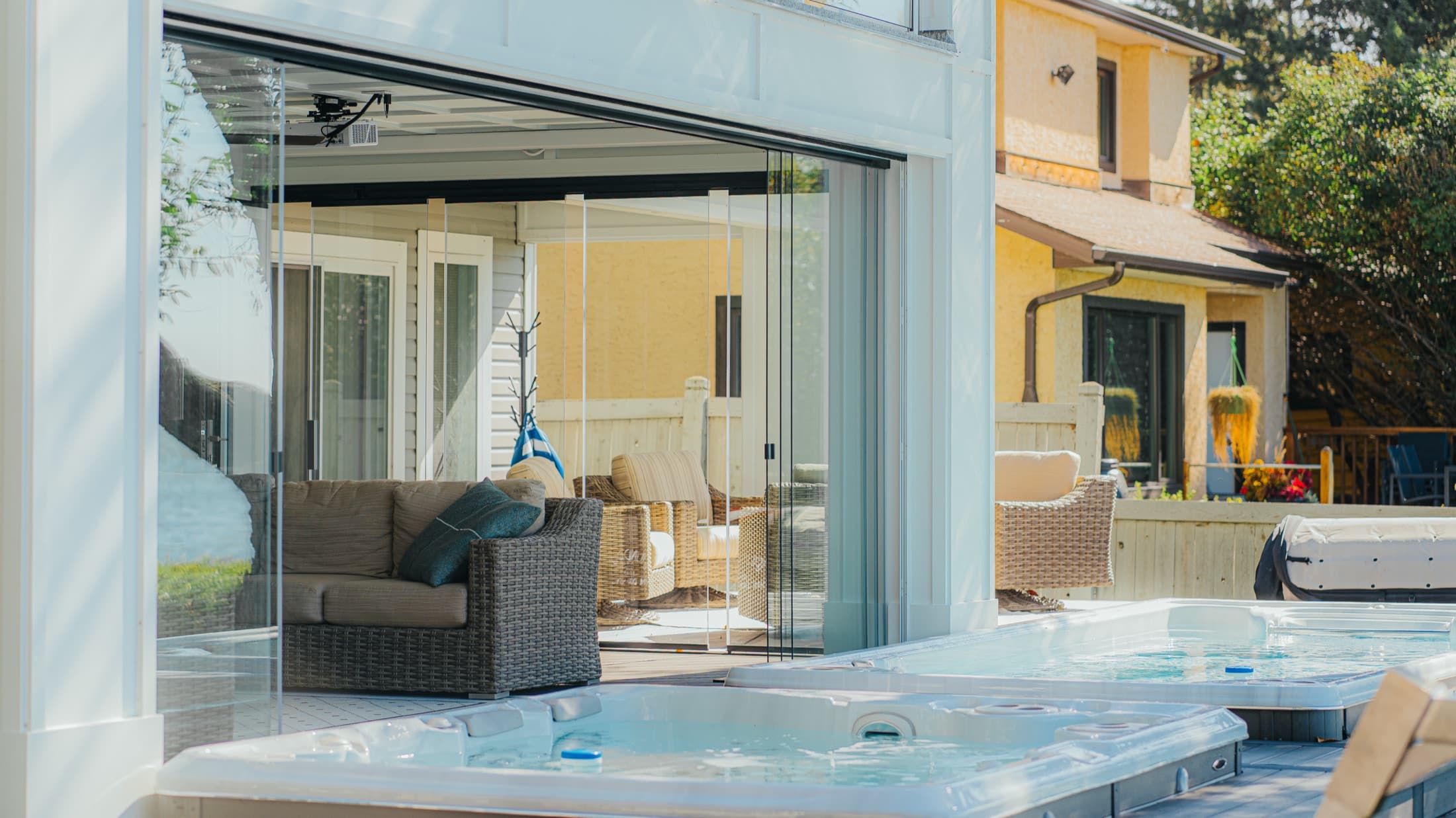 Retractable glass panels around a covered patio