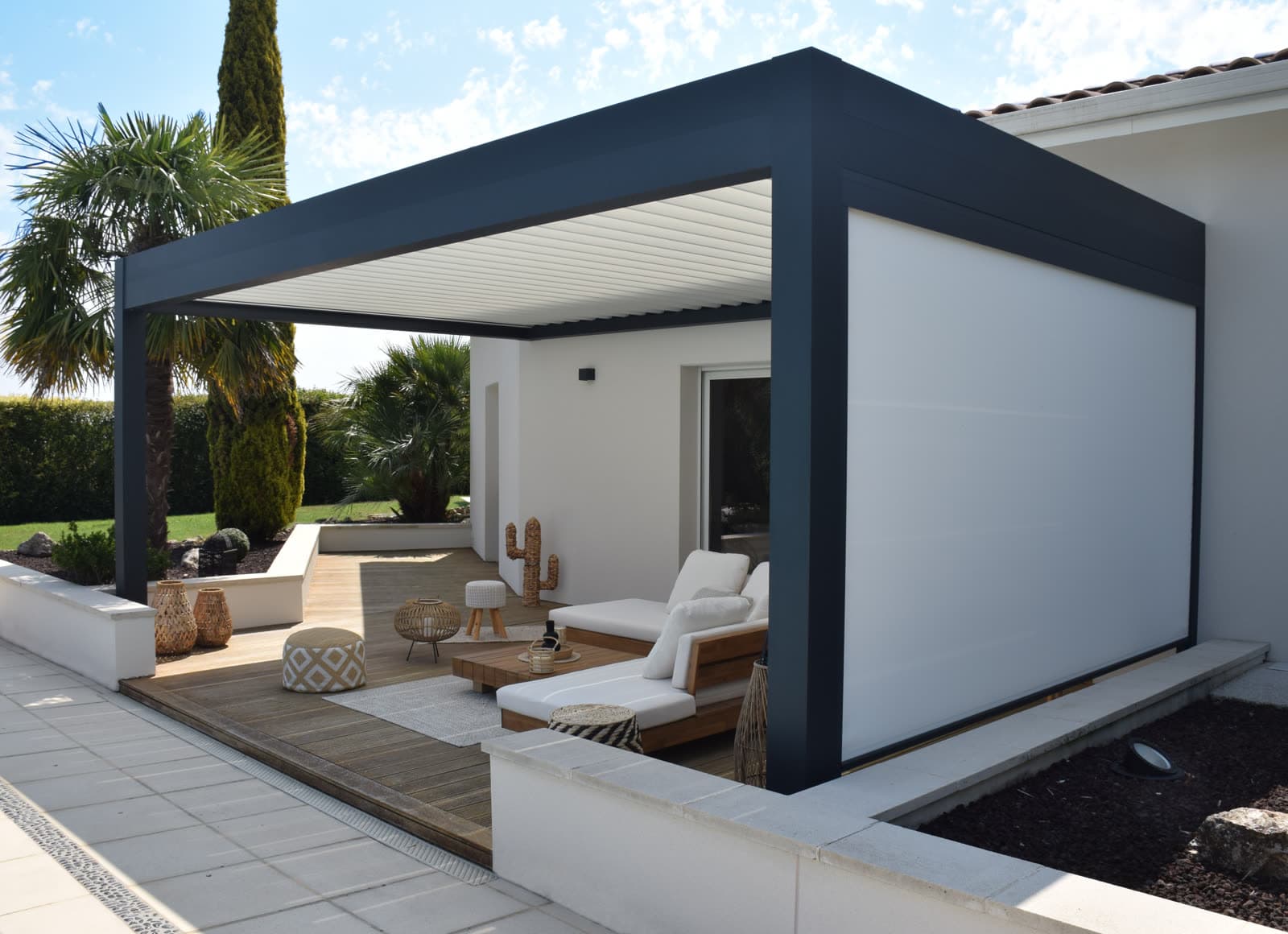 Motorized mesh screens deployed on white pergola providing UV protection